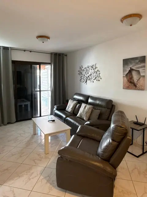 Wohnzimmer mit Ledercouch und Terrassentür